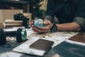 Globe, whole world in hands and compass, magnifying glass and book on route map on the table. Travel , Adventure and Discovery Royalty Free Stock Photo