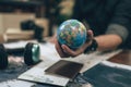 Globe, whole world in hands and compass, magnifying glass and book on route map on the table. Travel , Adventure and Discovery Royalty Free Stock Photo