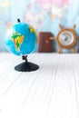 Globe on a wooden white background. The concept of travel Royalty Free Stock Photo