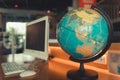 Globe world map and computer on desktop, Around the world travel Royalty Free Stock Photo