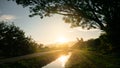 Gloden sundown and reflex water irrigation canal near small road