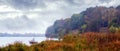 Gloomy autumn day. Autumn landscape with river and forest before the rain Royalty Free Stock Photo