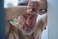 Gloomy blue-eyed Caucasian man pondering over something