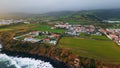 Gloomy coastal resort landscape drone view. Residential complex on woodland hill