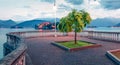 Gloomy evening cityscape of Stresa town. Wonderful summer view of Maggiore lake with Bella island on background, Province of Verba