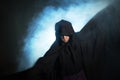 Gloomy image. Man in a black cloak. Demonic image. Magician illusionist Royalty Free Stock Photo