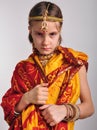 Gloomy little girl in traditional Indian clothing and jeweleries