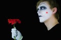 Gloomy mime with red flower Royalty Free Stock Photo