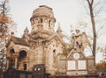 Gloomy monuments of the cemetery on sunny autumn afternoon. Royalty Free Stock Photo