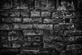 Gloomy old black brick wall - sinister dark background