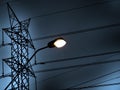 Gloomy street light and power line tower