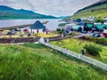 Gloomy summer view of Haldarsvik village with Haldorsvikar Church. Green morning scene of Streymoy island, Faroe Islands, Kingdom