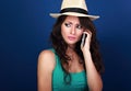 Gloomy unhappy frustration woman in summer hat talking on mobile