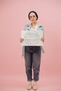 Gloomy, weared down female eco activist in a cap showing earth banner