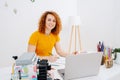 Glorious artist woman drawing behind work desk, looking at camera Royalty Free Stock Photo