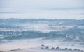 Glorious landscape image of layers of mist rolling over South Downs National Park English countryside during misty Summer sunrise Royalty Free Stock Photo