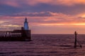 A glorious morning at Blyth beach, with a beautiful sunrise over the old wooden Pier stretching out to the North Sea Royalty Free Stock Photo