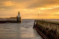A glorious morning at Blyth beach, with a beautiful sunrise over the old wooden Pier stretching out to the North Sea Royalty Free Stock Photo