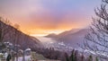 Glorious sunset in the italian Alps. Beautiful sky over snowy valley idyllic village and snowcapped mountain peaks. Winter in Royalty Free Stock Photo