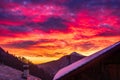 Glorious sunset in the italian Alps. Beautiful sky over snowy valley idyllic village and snowcapped mountain peaks. Winter in Royalty Free Stock Photo