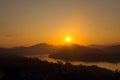 Glorious sunset over hazy mountains by the Mekong river. View from Mount Phou Si, in Luang Prabang, Laos. Royalty Free Stock Photo