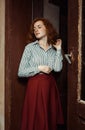 Glorious young red haired model in stripred shirt and red skirt Royalty Free Stock Photo