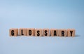 GLOSSARY word concept written on wooden cubes lying on a light table and light background Royalty Free Stock Photo