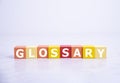 Glossary - word from wooden blocks with letters, alphabetical list with words meanings dictionary glossary concept, top view on