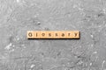 Glossary word written on wood block. Glossary text on cement table for your desing, Top view concept