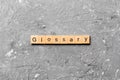 Glossary word written on wood block. Glossary text on cement table for your desing, Top view concept Royalty Free Stock Photo