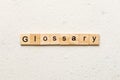 Glossary word written on wood block. Glossary text on cement table for your desing, Top view concept Royalty Free Stock Photo