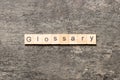 Glossary word written on wood block. Glossary text on cement table for your desing, Top view concept Royalty Free Stock Photo