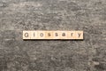 glossary word written on wood block. glossary text on table, concept