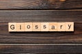 Glossary word written on wood block. Glossary text on wooden table for your desing, Top view concept Royalty Free Stock Photo