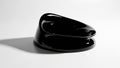 Glossy black abstract sculpture on a smooth, reflective surface Royalty Free Stock Photo