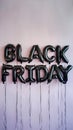 Glossy black balloons spelling BLACK FRIDAY on neutral background Royalty Free Stock Photo
