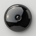 A Glossy Black Button on Grey Surface Royalty Free Stock Photo