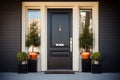 glossy black door with topiaries on either side