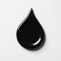 A glossy, black, tear-shaped object placed on a white surface. The smooth texture an Royalty Free Stock Photo