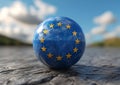Glossy blue sphere with golden stars on textured surface under open sky. symbolizing unity, concept of european union