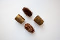 Glossy golden candle holders and pine cones