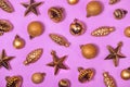 Glossy golden Xmas tree decorations background. Vintage shiny Christmas ornaments on magenta. Old fashioned star shaped