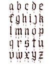 Glossy letters of the gothic font made of melted chocolate with dripping drops