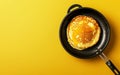 A glossy pancake lavishly coated in syrup lies in a frying pan, the glossy texture highlighted by a bright yellow