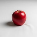 Glossy red apple is centered against a plain white backgroun Royalty Free Stock Photo