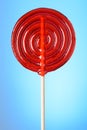 Glossy red lollipop on wooden stick