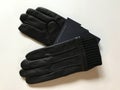 A pair of black patent leather gloves for winter