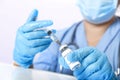 A gloved doctor fills a syringe with a vaccine to prevent the virus. Royalty Free Stock Photo