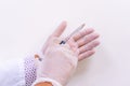 Gloved doctor hands holding an injection vial of a hyaluronic acid HA based dermal filler for anti-aging and volumizing face tre