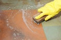 Gloved hand cleaning of dirty filthy floor Royalty Free Stock Photo